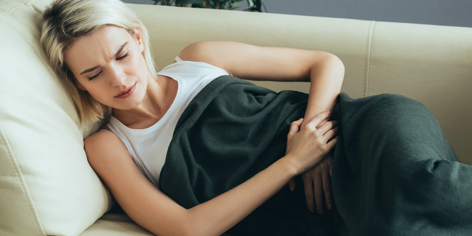 woman lying down wanting cbd for pms symptoms