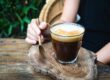 image of woman mixing CBD and caffeine into her morning routine with coffee