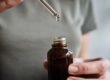 image of someone measuring their CBD dosage with an eye dropper